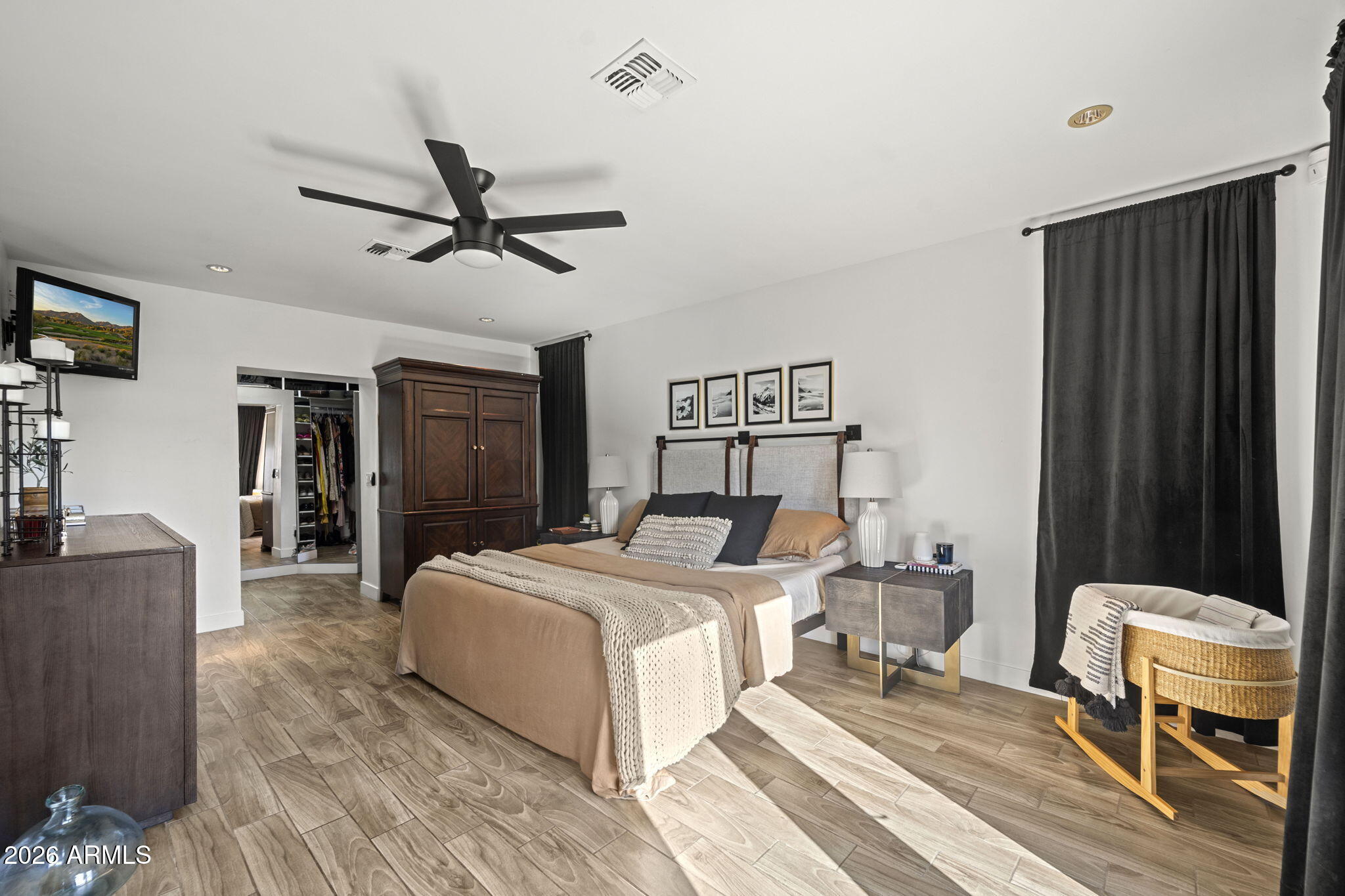 4215 East Flower Street Phoenix, AZ 85018 - Photo 24 of 39 a bedroom with a bed and a chair