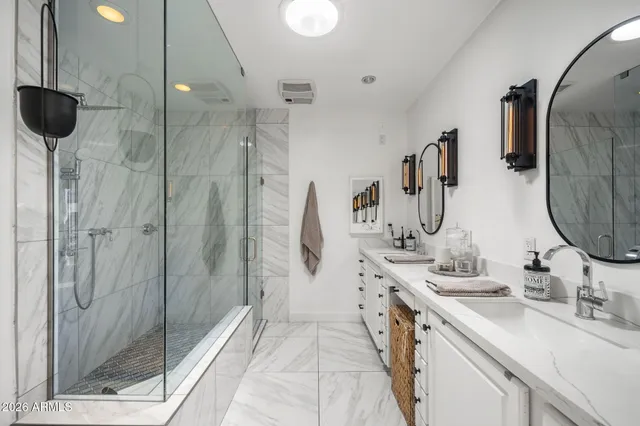 a bathroom with a double vanity sink and a mirror