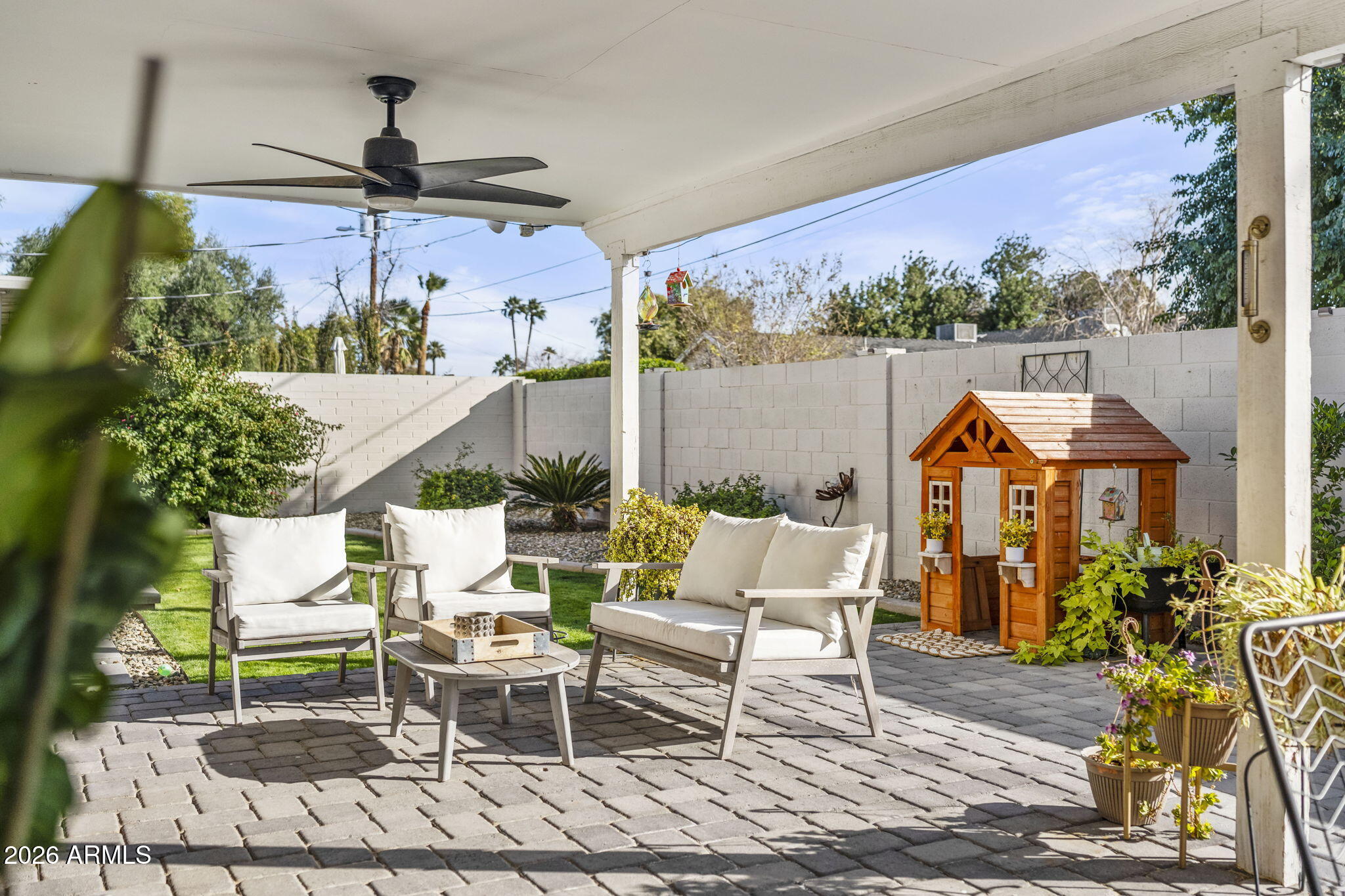 4215 East Flower Street Phoenix, AZ 85018 - Photo 36 of 39 a view of a patio with table and chairs potted plants