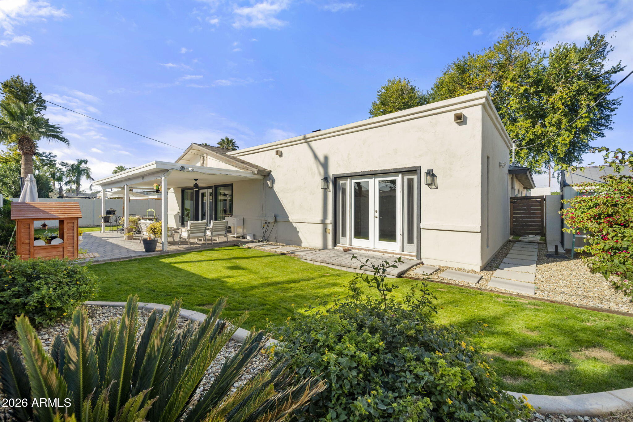 4215 East Flower Street Phoenix, AZ 85018 - Photo 38 of 39 a view of a white house with a big yard and potted plants