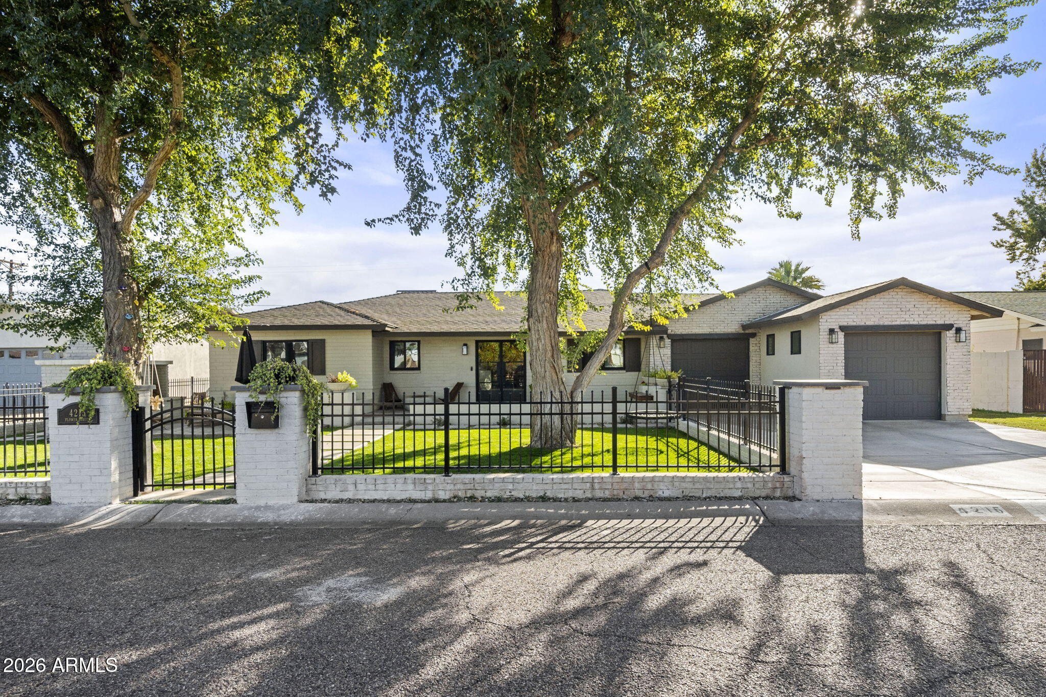 4215 East Flower Street Phoenix, AZ 85018 - Photo 4 of 39 a view of house with a swimming pool and a big yard