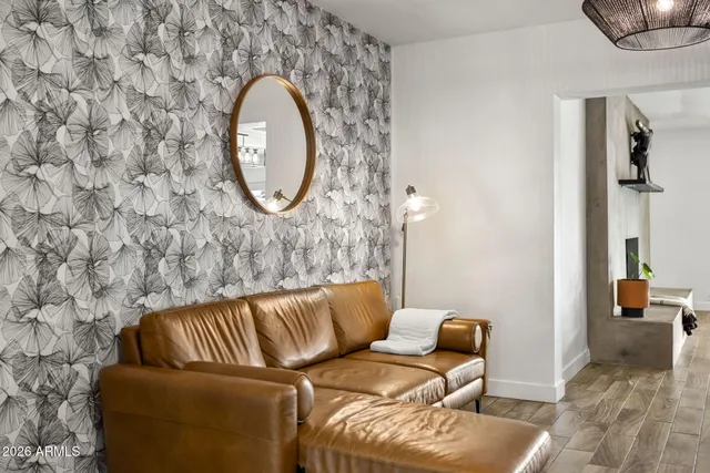 a living room with furniture and a chandelier