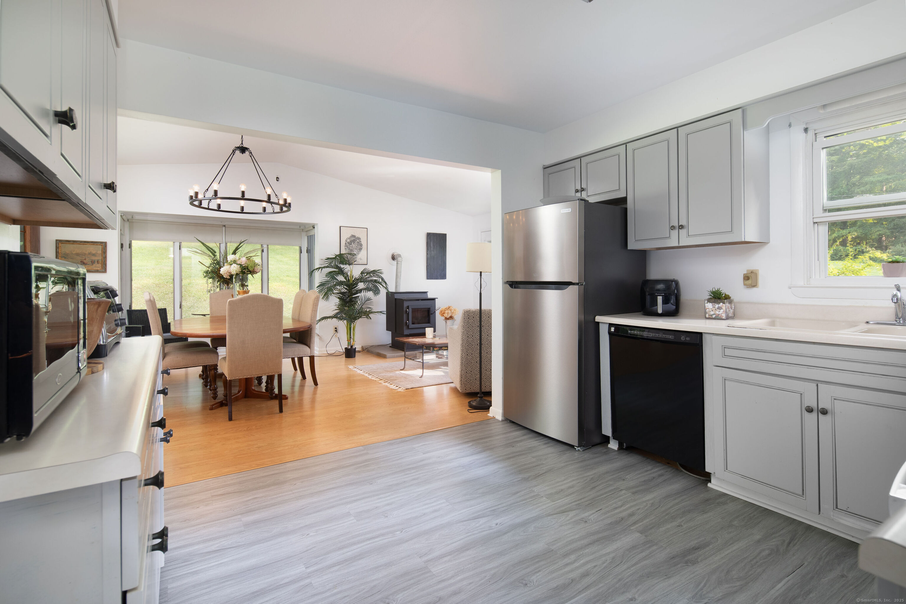 37 Greene Avenue North Canaan, CT 06018 - Photo 3 of 17 a kitchen with stainless steel appliances granite countertop a refrigerator a stove top oven a sink dishwasher and white cabinets with wooden floor