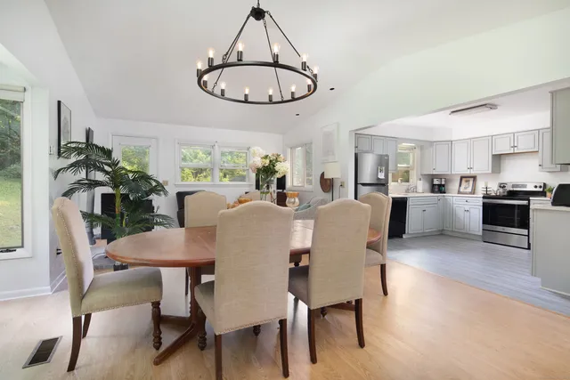 a view of a dining room with furniture window and wooden floor