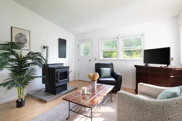 a living room with furniture a flat screen tv and a fireplace