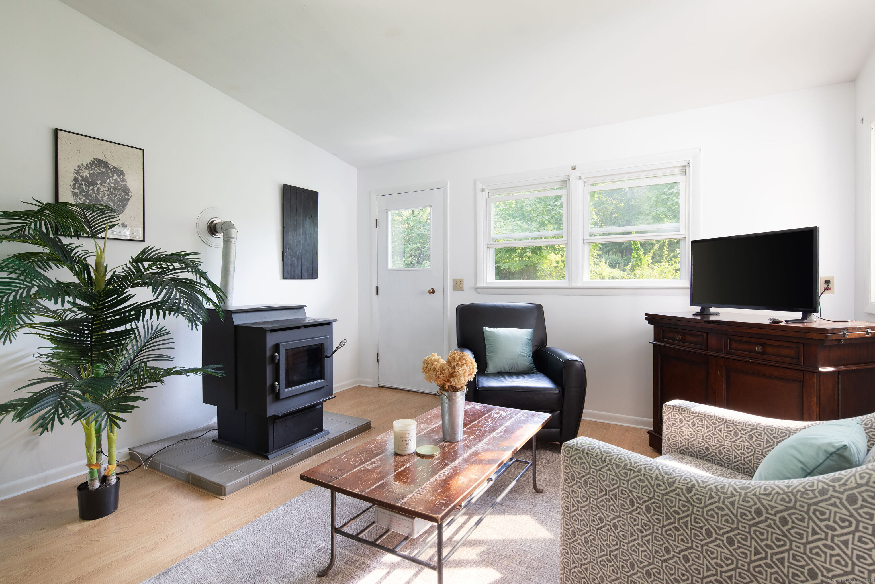 37 Greene Avenue North Canaan, CT 06018 - Photo 8 of 17 a living room with furniture a flat screen tv and a fireplace
