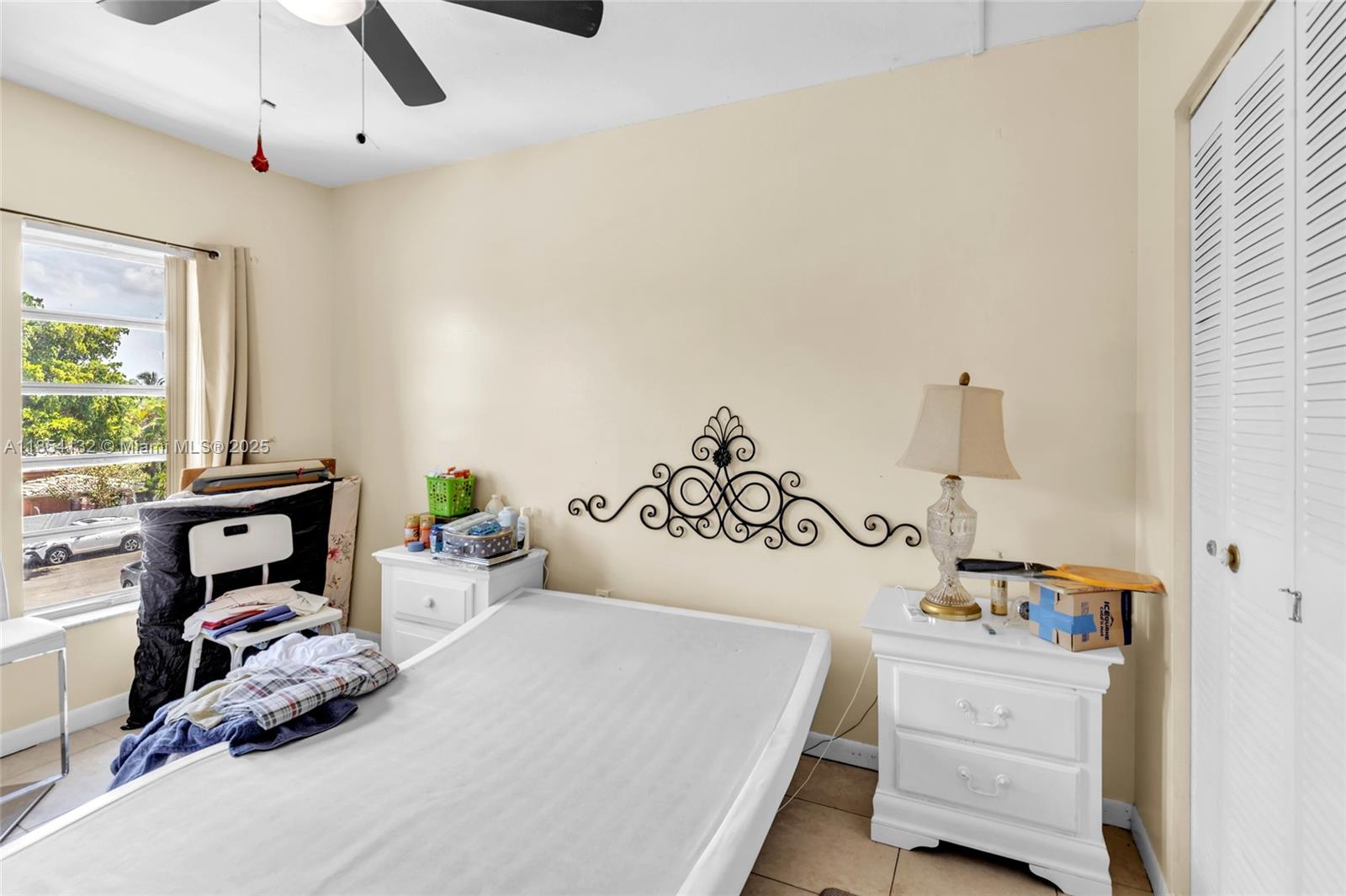 1855 West 62nd Street, Unit E306 Hialeah, FL 33012 - Photo 14 of 35 a bedroom with a bed and a window