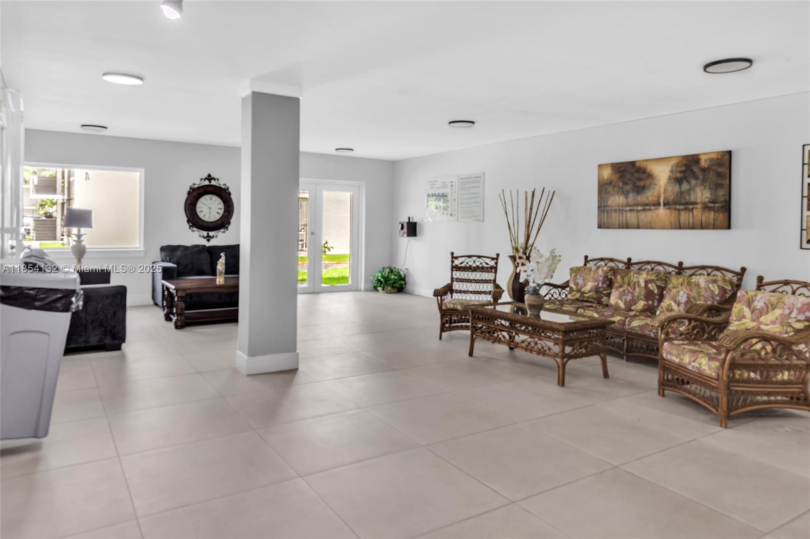 1855 West 62nd Street, Unit E306 Hialeah, FL 33012 - Photo 21 of 35 a living room with furniture and wooden floor