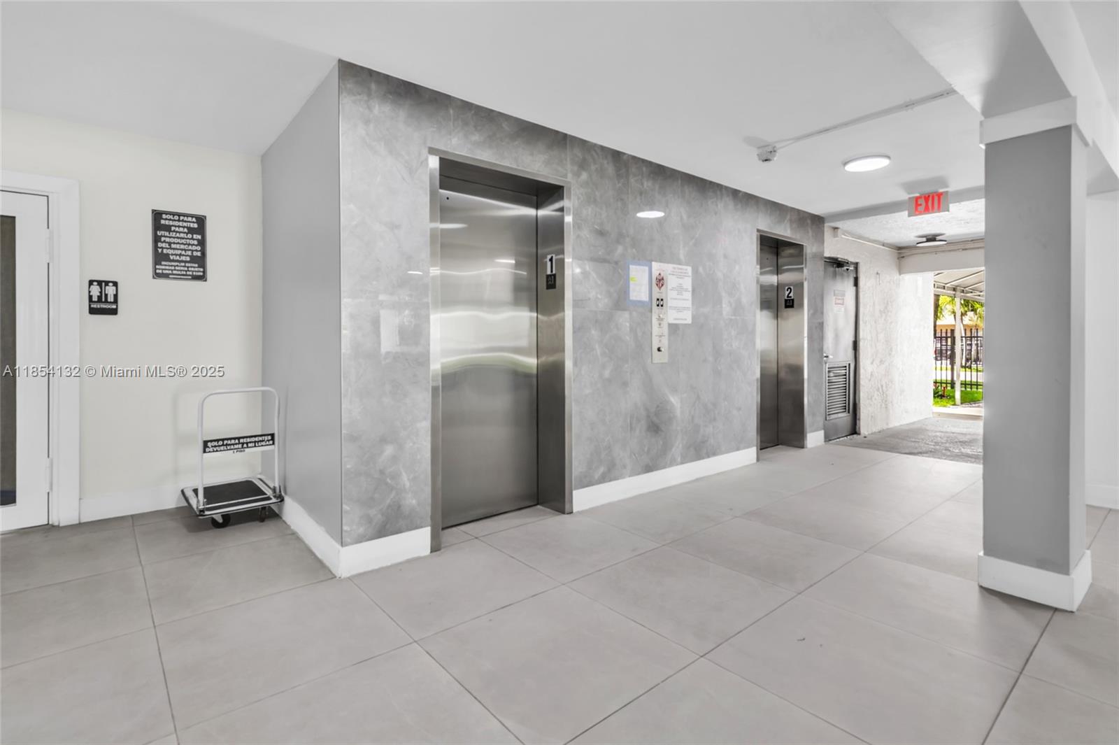 1855 West 62nd Street, Unit E306 Hialeah, FL 33012 - Photo 23 of 35 a view of a hallway with closet and bathroom