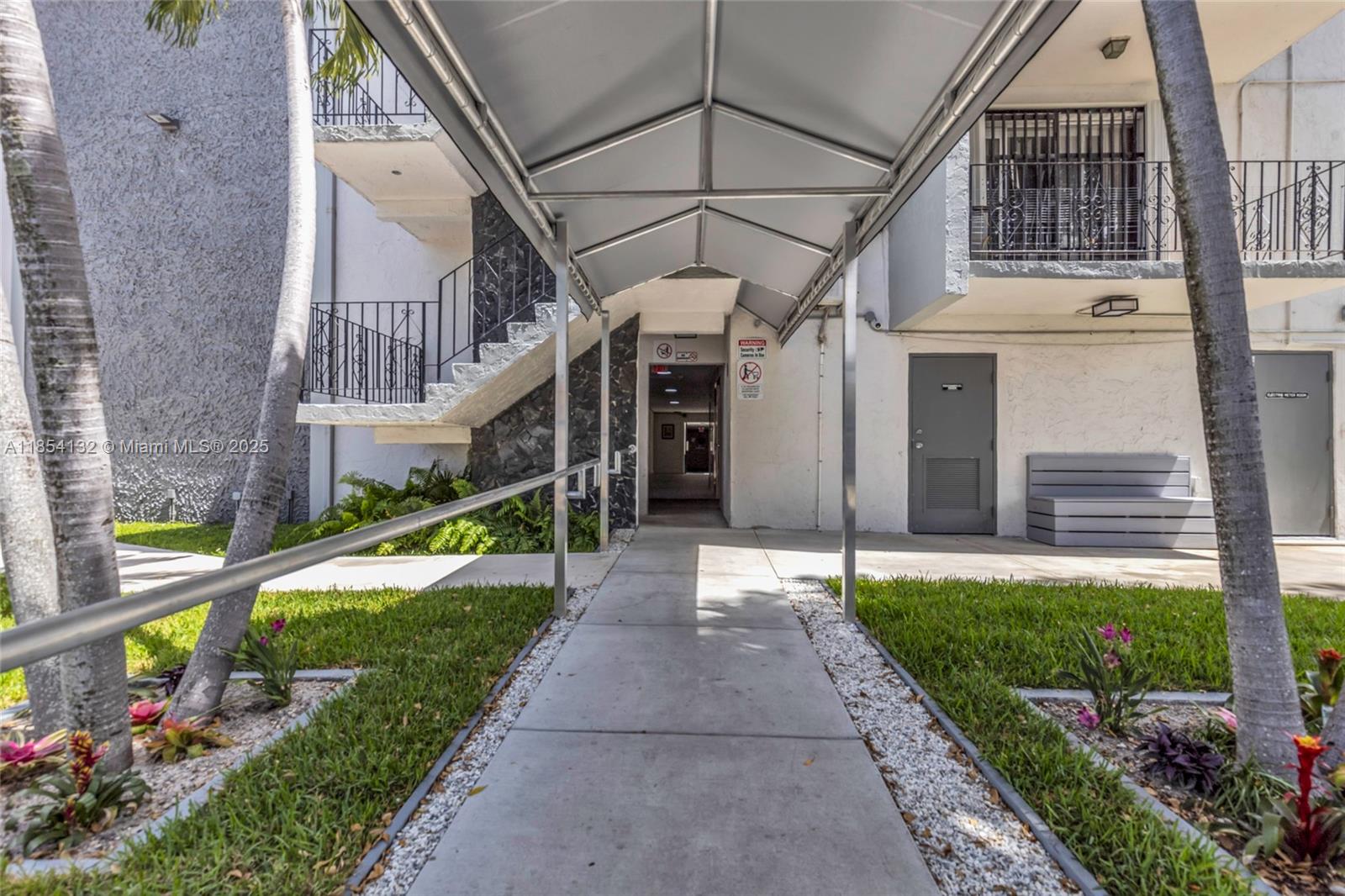 1855 West 62nd Street, Unit E306 Hialeah, FL 33012 - Photo 25 of 35 a view of a house with a yard