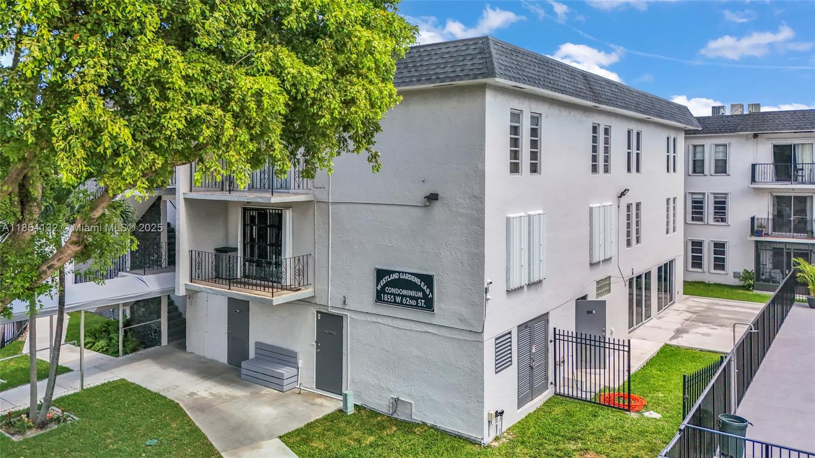 1855 West 62nd Street, Unit E306 Hialeah, FL 33012 - Photo 26 of 35 a view of a house with backyard and sitting area