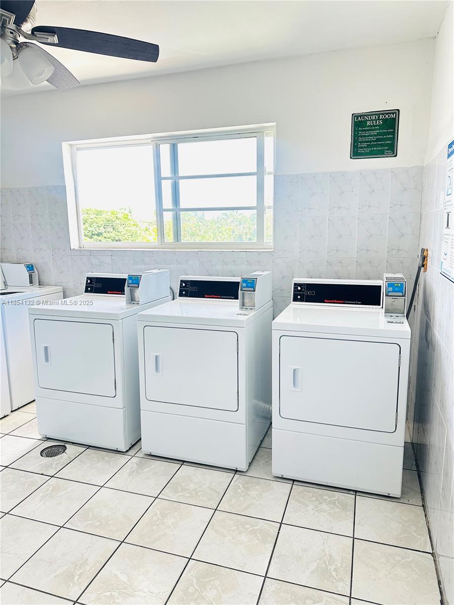 1855 West 62nd Street, Unit E306 Hialeah, FL 33012 - Photo 34 of 35 a utility room with dryer washer and a window