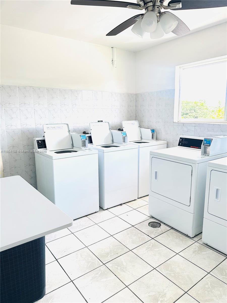 1855 West 62nd Street, Unit E306 Hialeah, FL 33012 - Photo 35 of 35 a kitchen with a sink cabinets and window