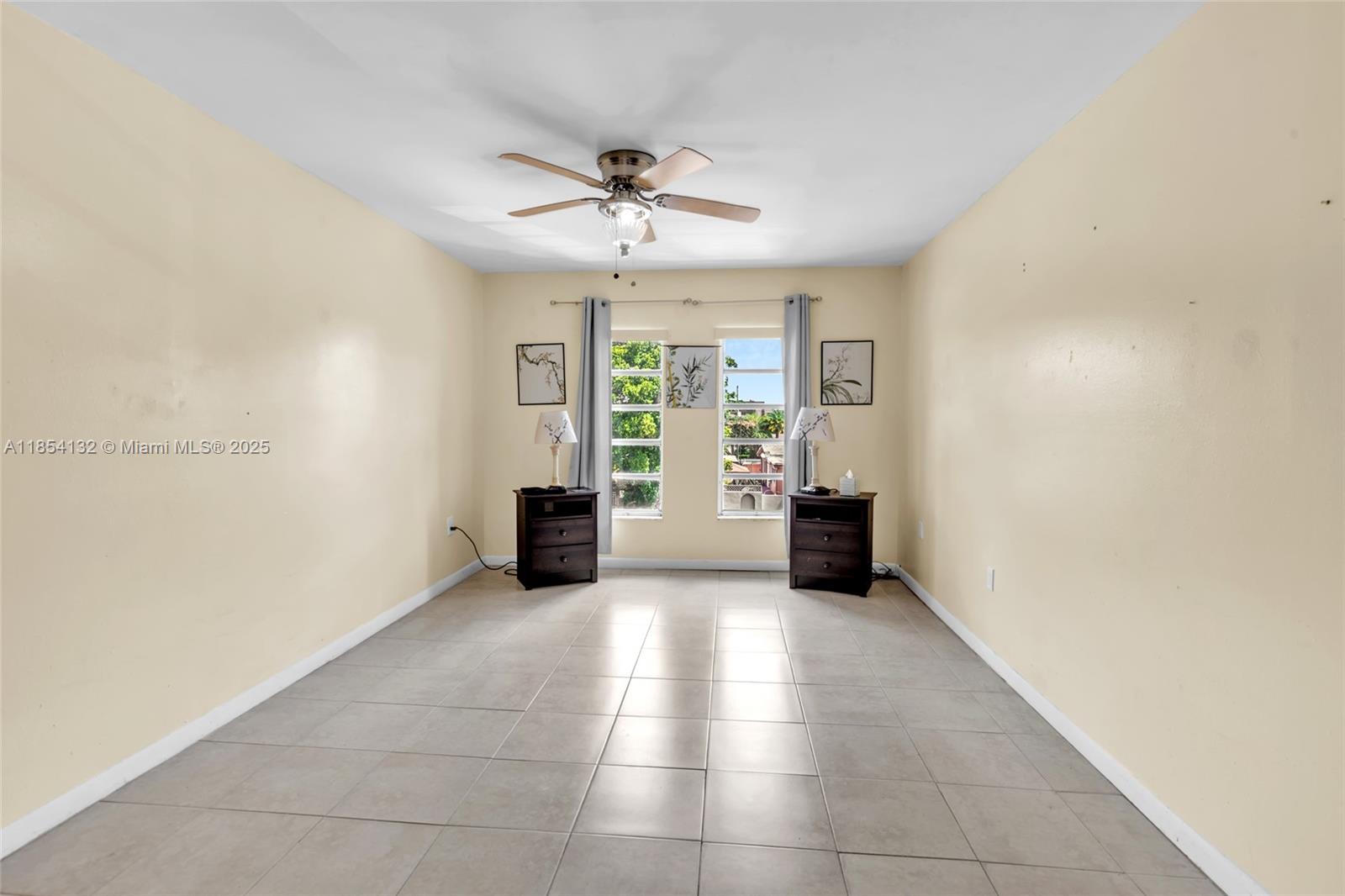 1855 West 62nd Street, Unit E306 Hialeah, FL 33012 - Photo 9 of 35 a view of an empty room with a window