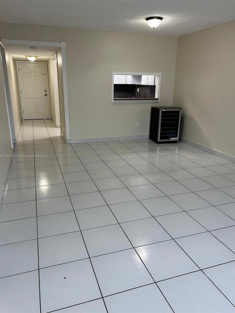 6125 West 20th Avenue, Unit 217 Hialeah, FL 33012 - Photo 9 of 16 a view of a livingroom with kitchen