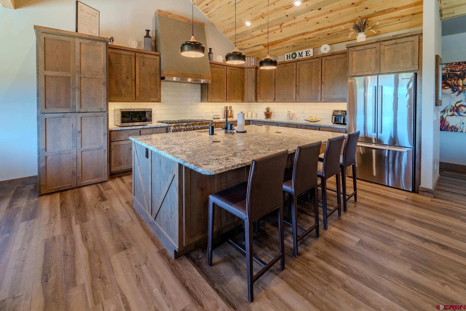 1700 Thoroughbred Road Durango, CO 81303 - Photo 13 of 45 a kitchen with kitchen island granite countertop wooden floors and stainless steel appliances