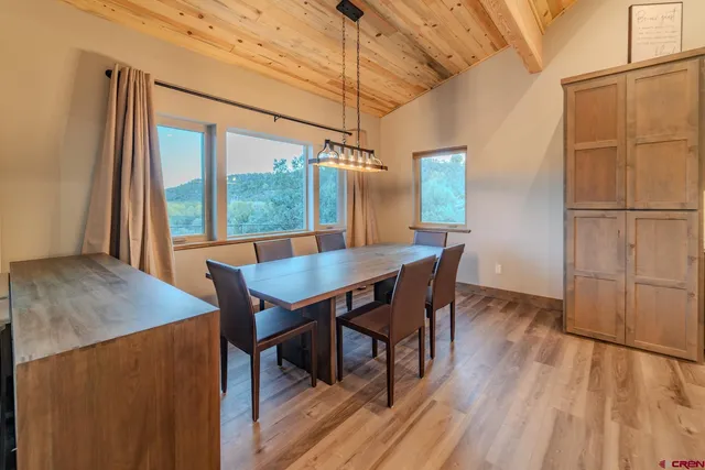 a view of a dining room with furniture window and wooden floor