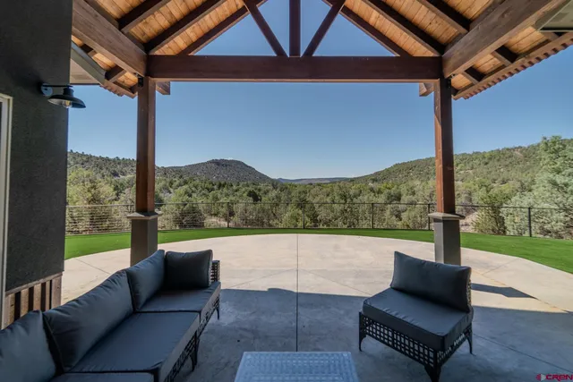 a bedroom with furniture and a large window