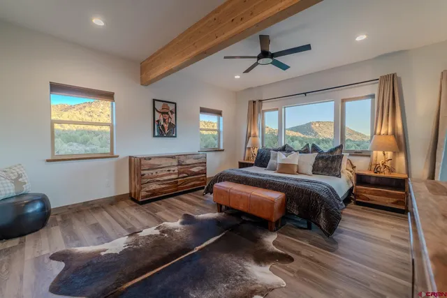 a bedroom with a bed furniture and a flat screen tv