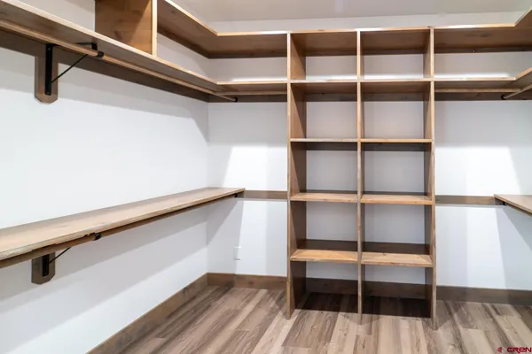 a workspace with wooden floor and furniture
