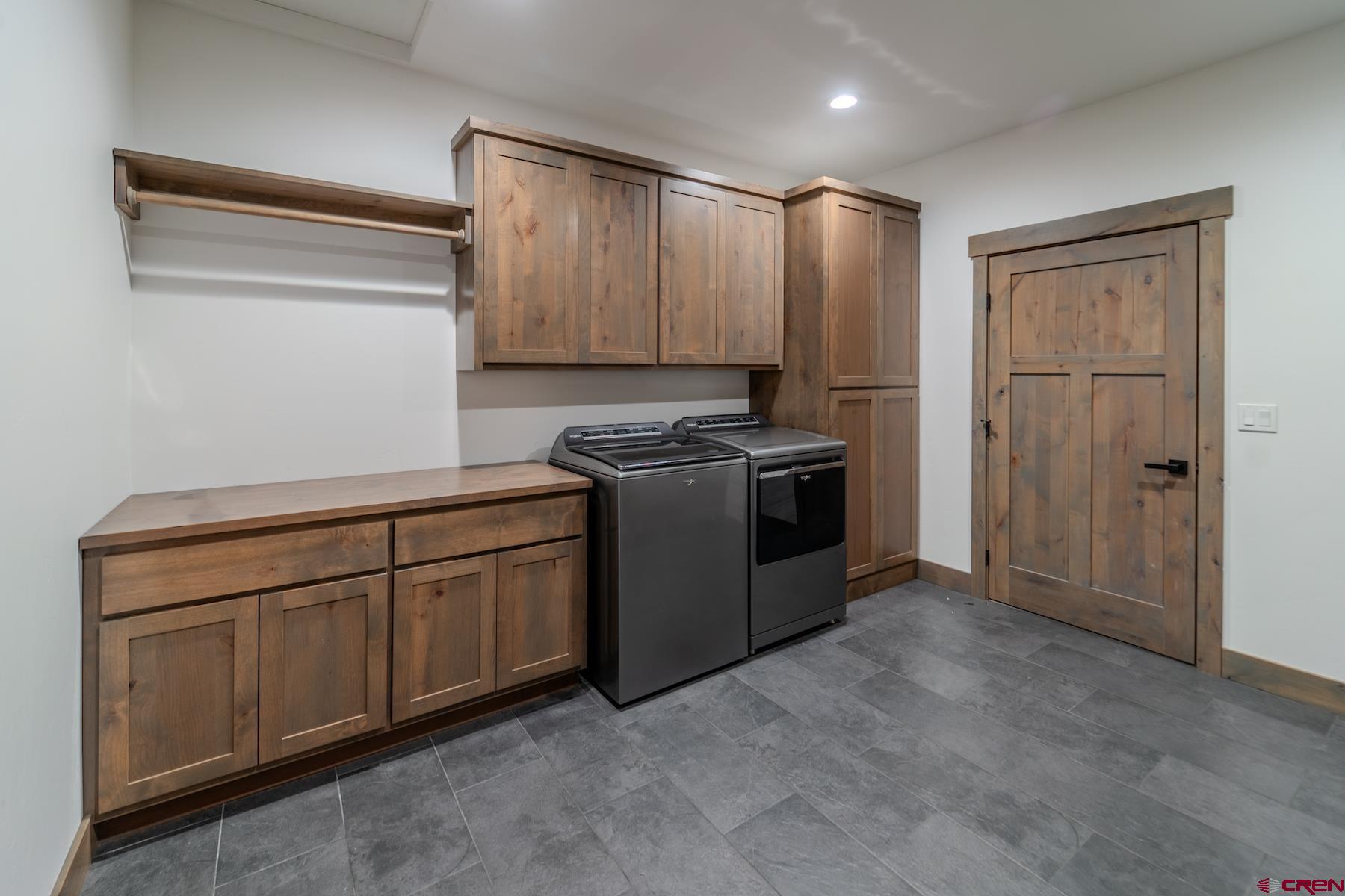 1700 Thoroughbred Road Durango, CO 81303 - Photo 32 of 45 a kitchen with stainless steel appliances granite countertop a refrigerator a sink a stove and white cabinets