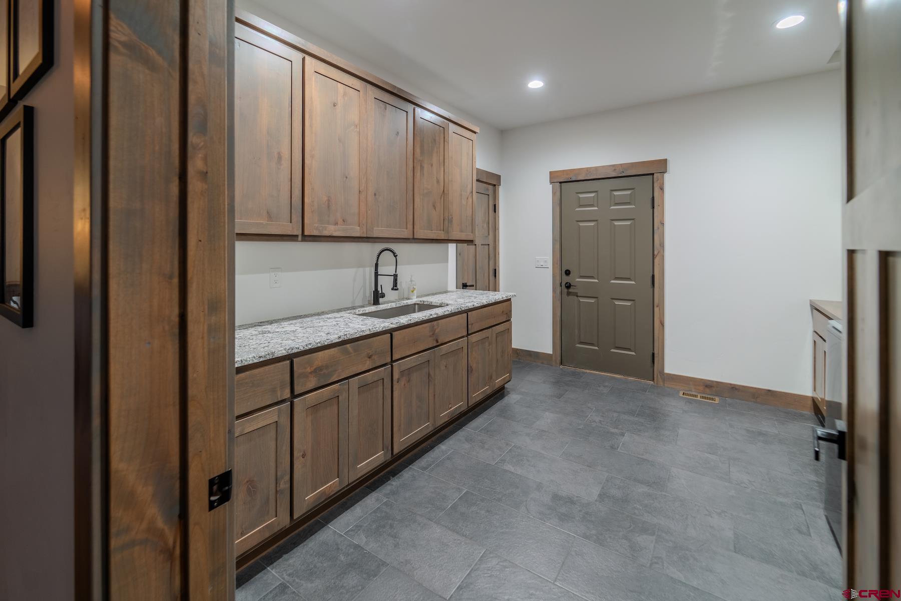 1700 Thoroughbred Road Durango, CO 81303 - Photo 33 of 45 a kitchen with a refrigerator and a sink