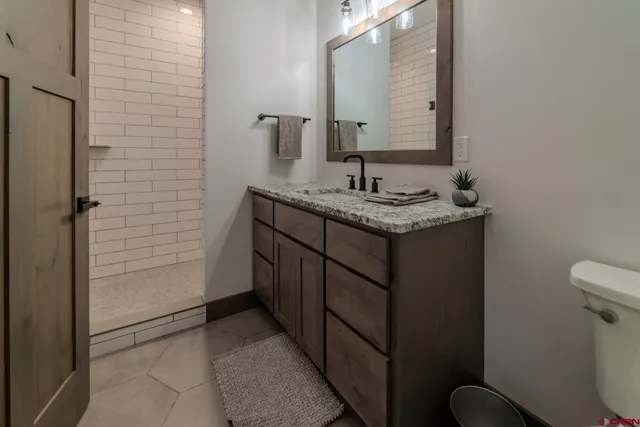 a view of an empty room and a bathroom