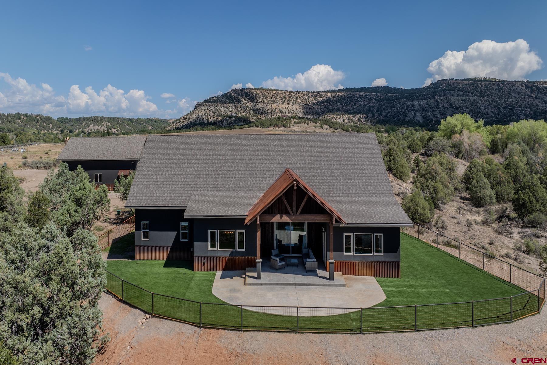 1700 Thoroughbred Road Durango, CO 81303 - Photo 42 of 45 a front view of a house with a yard and garage