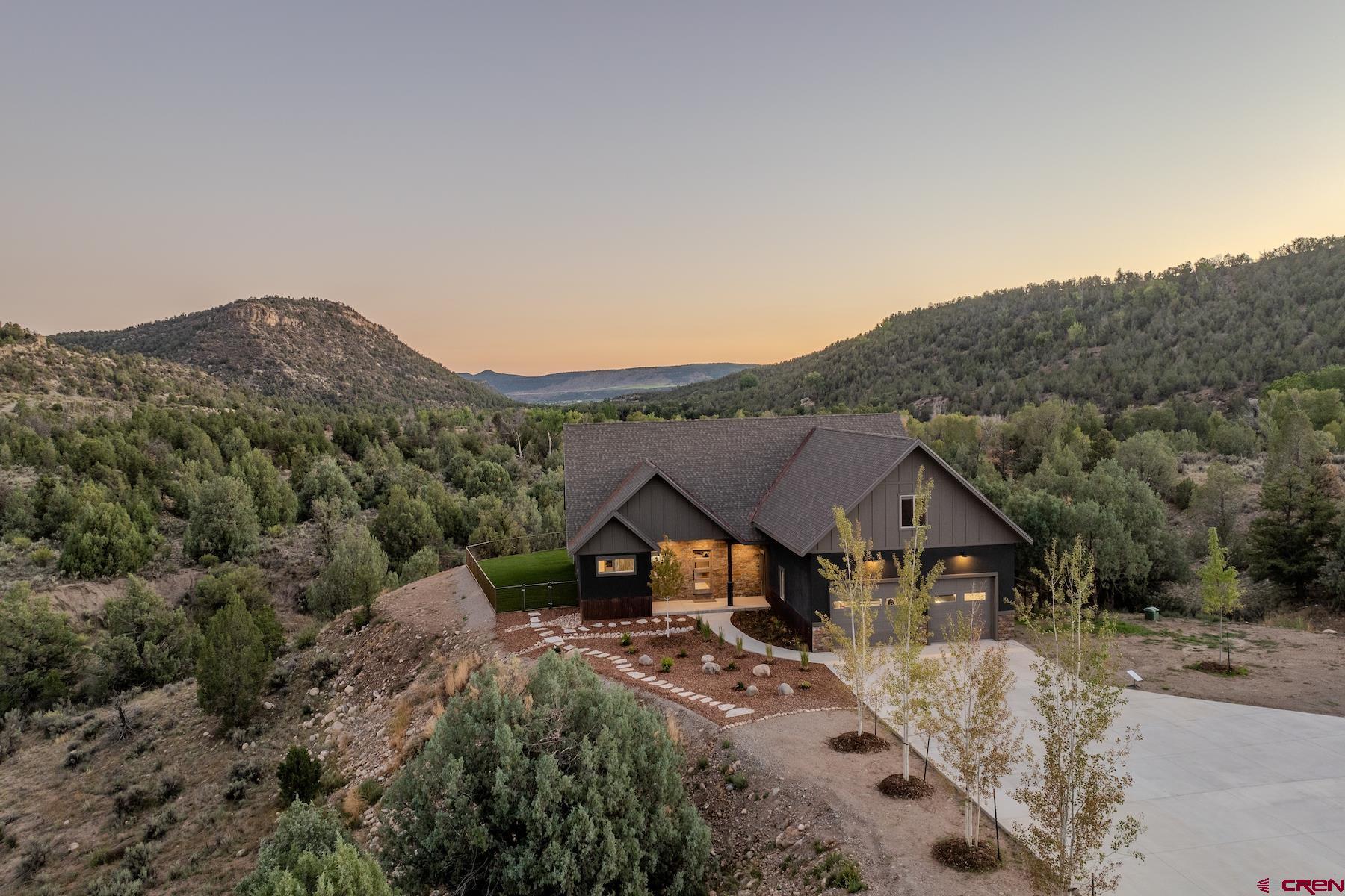 1700 Thoroughbred Road Durango, CO 81303 - Photo 6 of 45 a view of house with green field