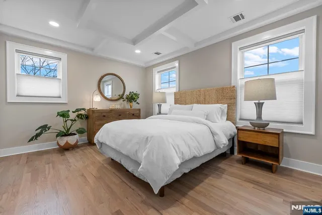 a bedroom with a large bed and a potted plant