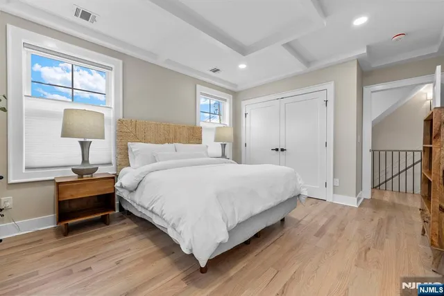 a bedroom with a bed and a table chair