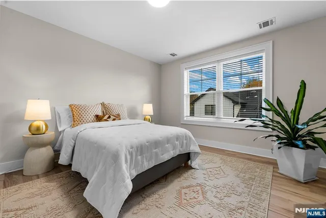 a bedroom with furniture and a wooden floor