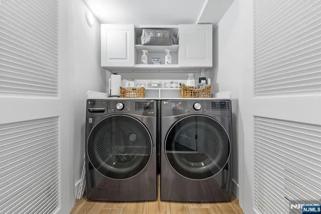 a living room with furniture kitchen view and a flat screen tv