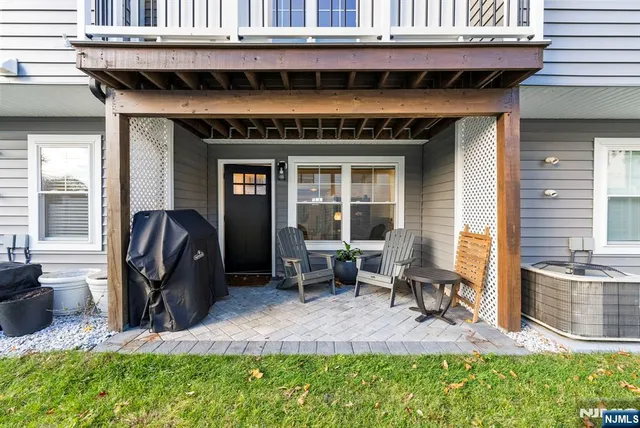 a living room with furniture kitchen and a wooden floor