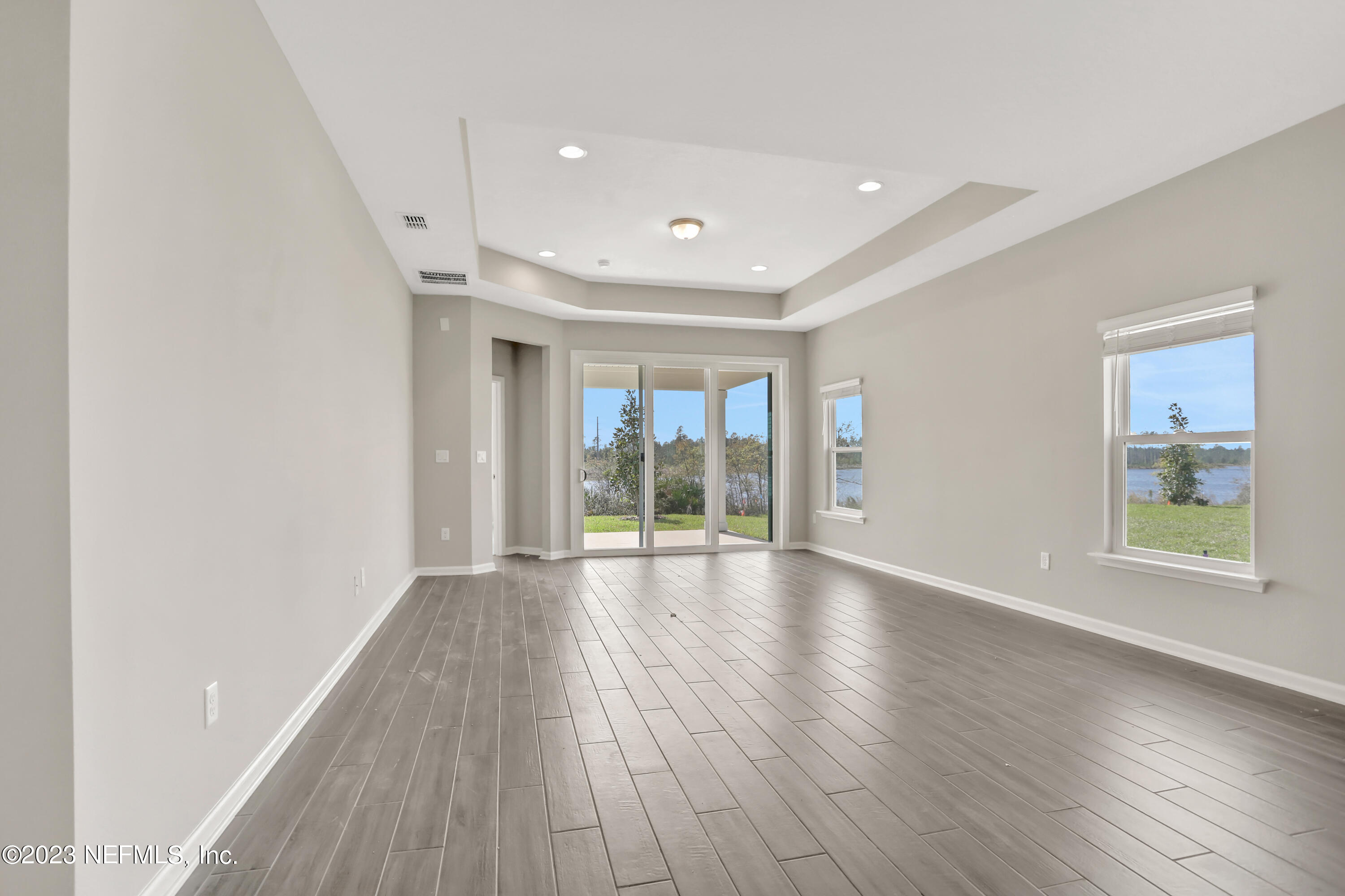152 Torres Trace St. Augustine, FL 32095 - Photo 11 of 32 a view of an empty room with wooden floor and a window