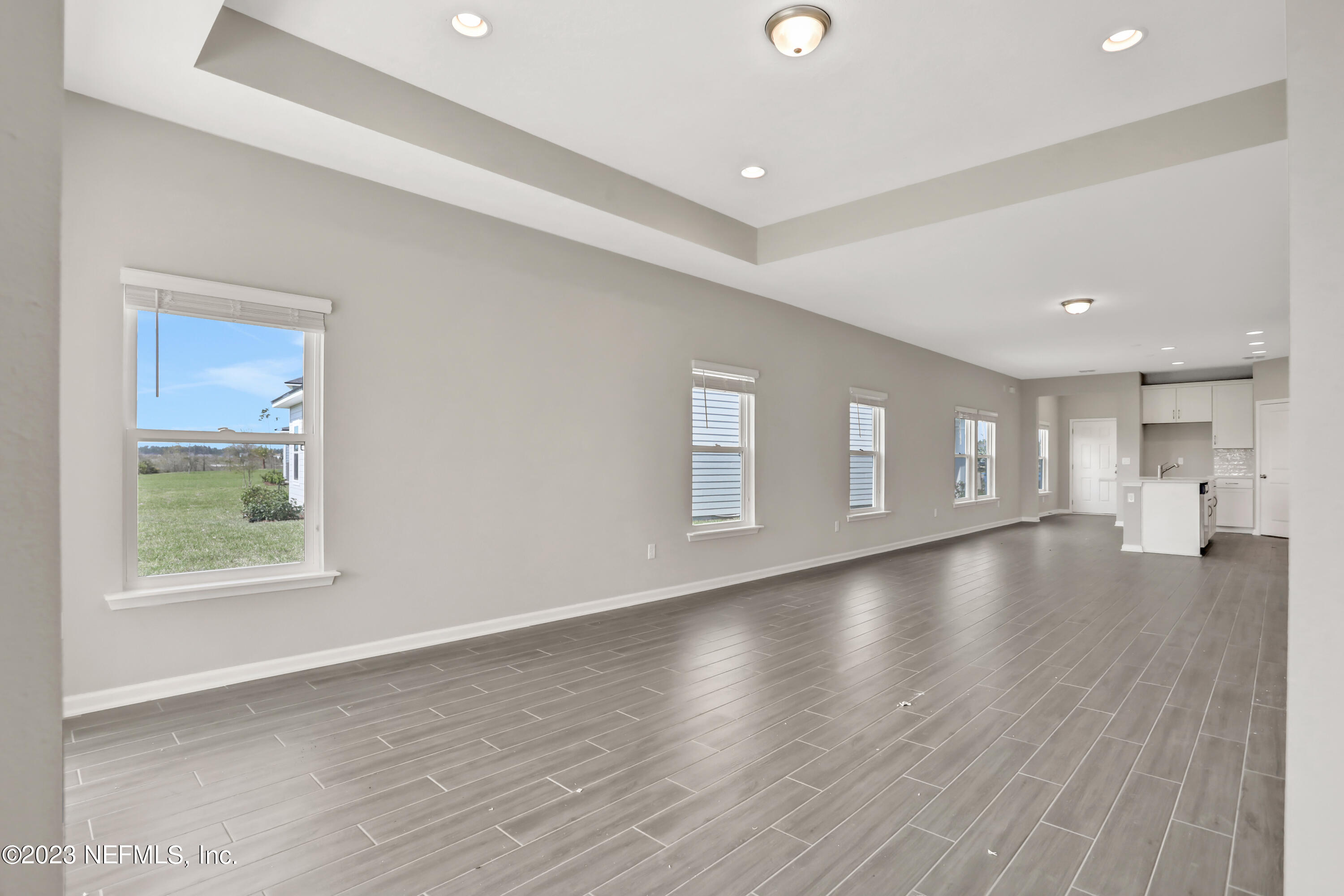 152 Torres Trace St. Augustine, FL 32095 - Photo 13 of 32 a view of empty room with wooden floor and windows
