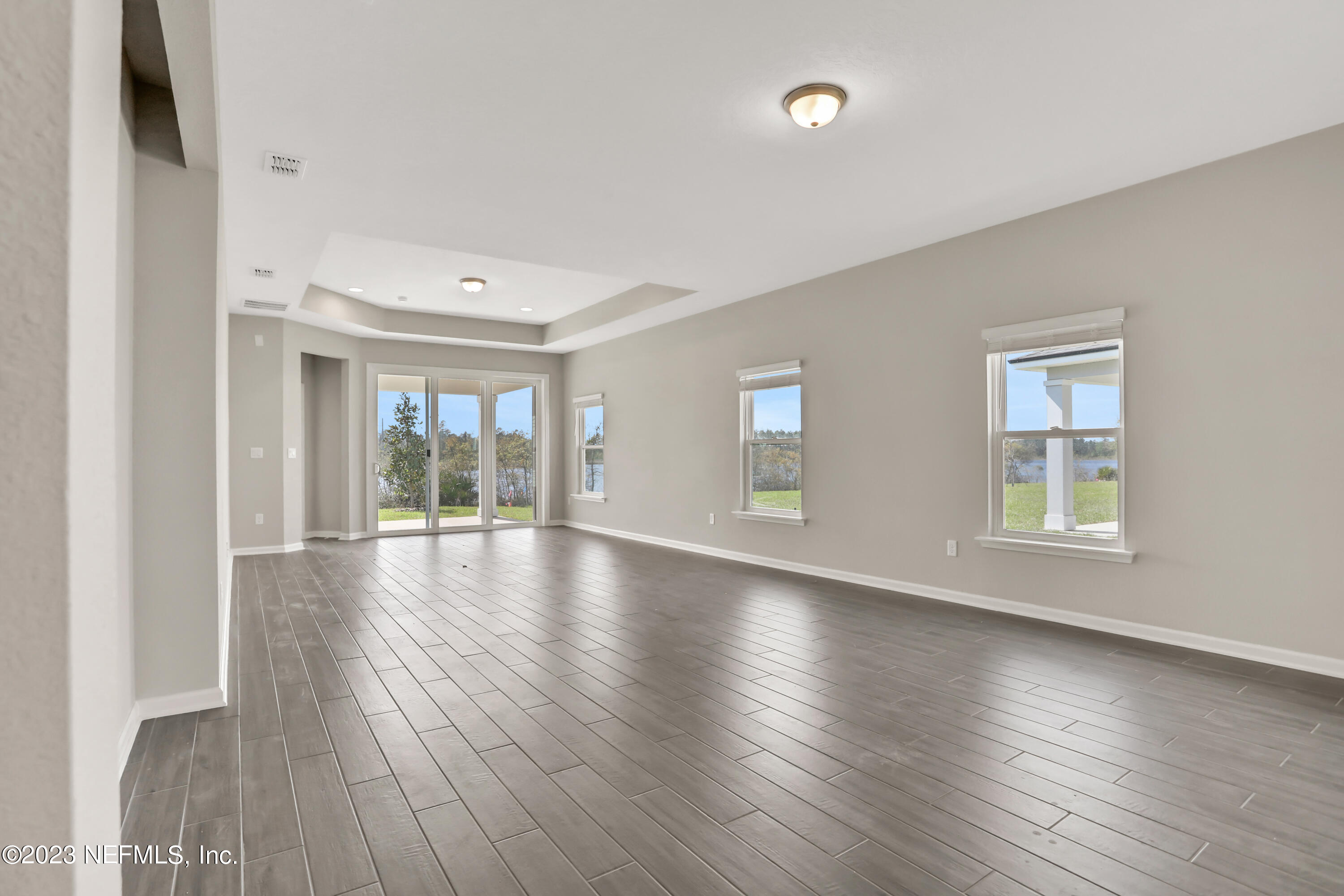 152 Torres Trace St. Augustine, FL 32095 - Photo 15 of 32 an empty room with wooden floor and windows