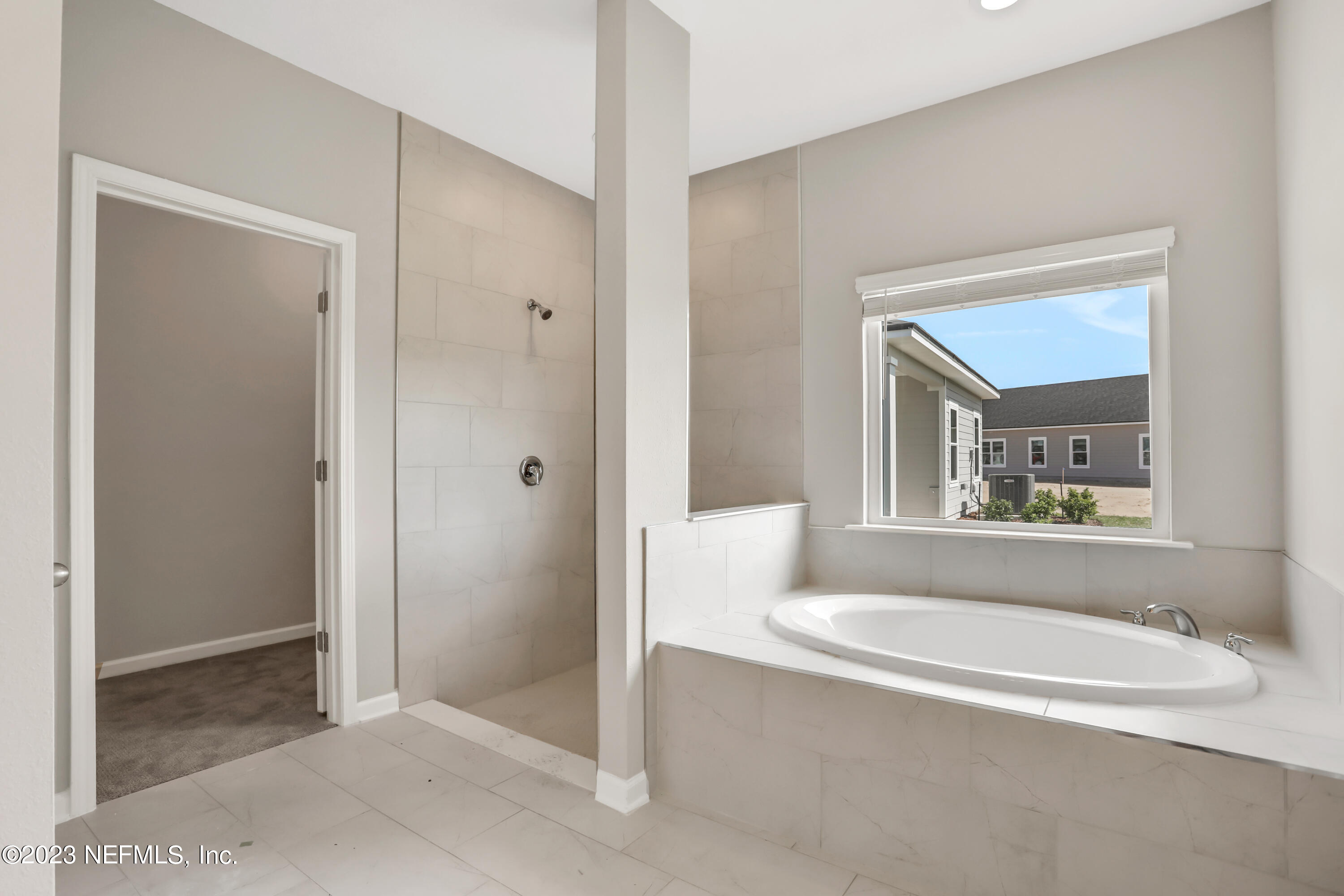 152 Torres Trace St. Augustine, FL 32095 - Photo 26 of 32 a bathroom with a bathtub and a shower