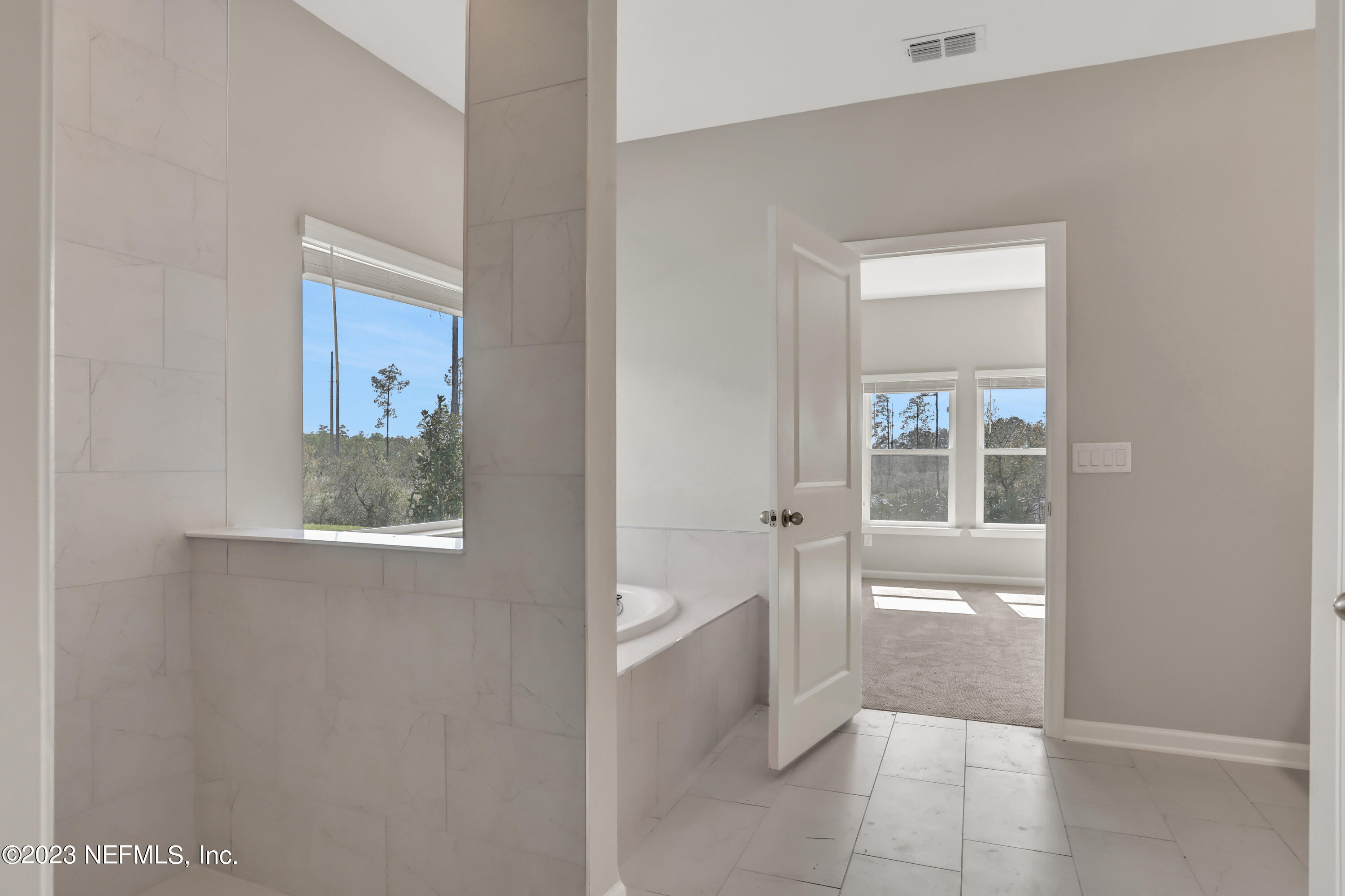 152 Torres Trace St. Augustine, FL 32095 - Photo 27 of 32 a bathroom with a tub shower and mirror