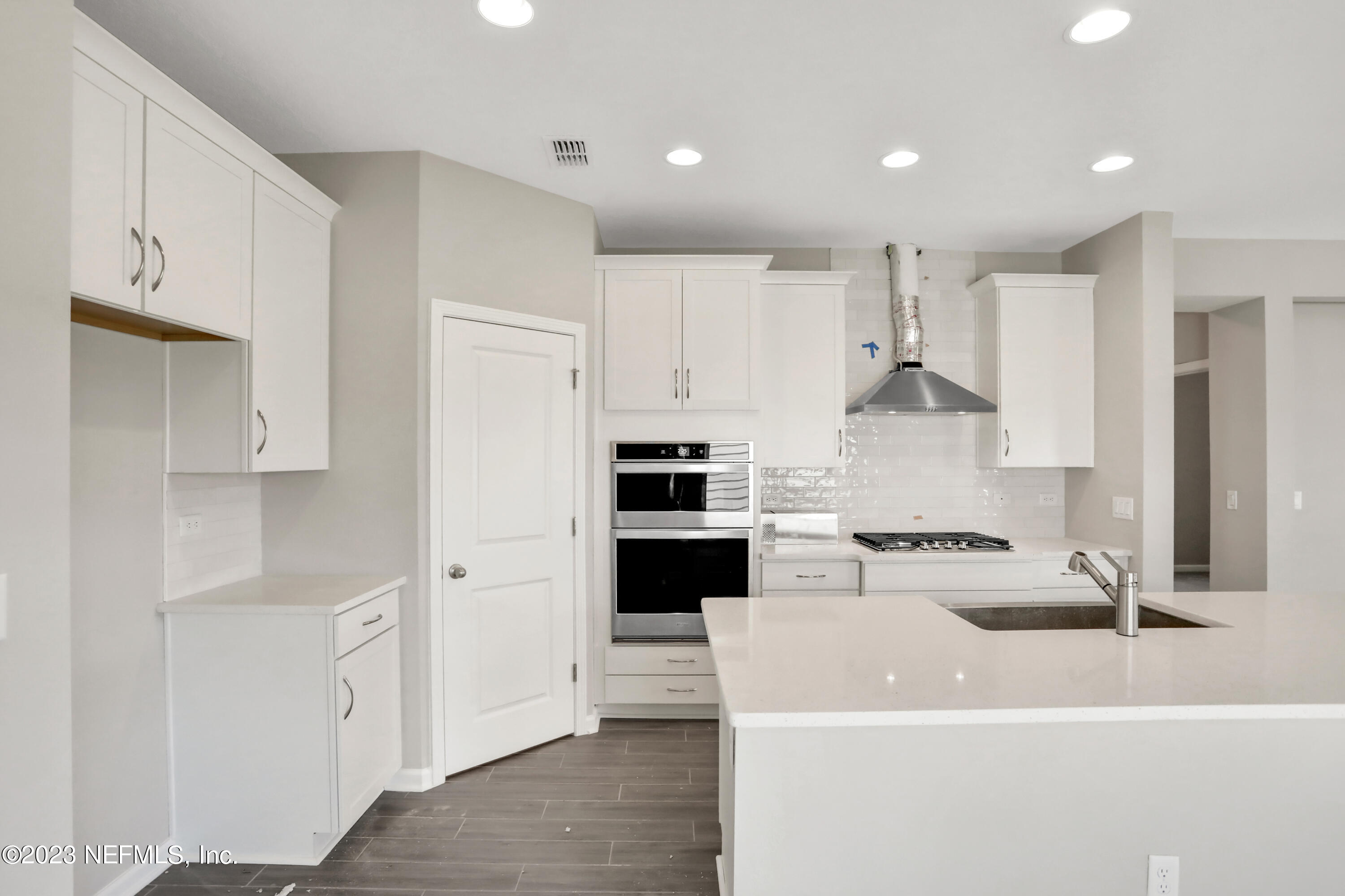 152 Torres Trace St. Augustine, FL 32095 - Photo 3 of 32 a kitchen with white cabinets and stainless steel appliances