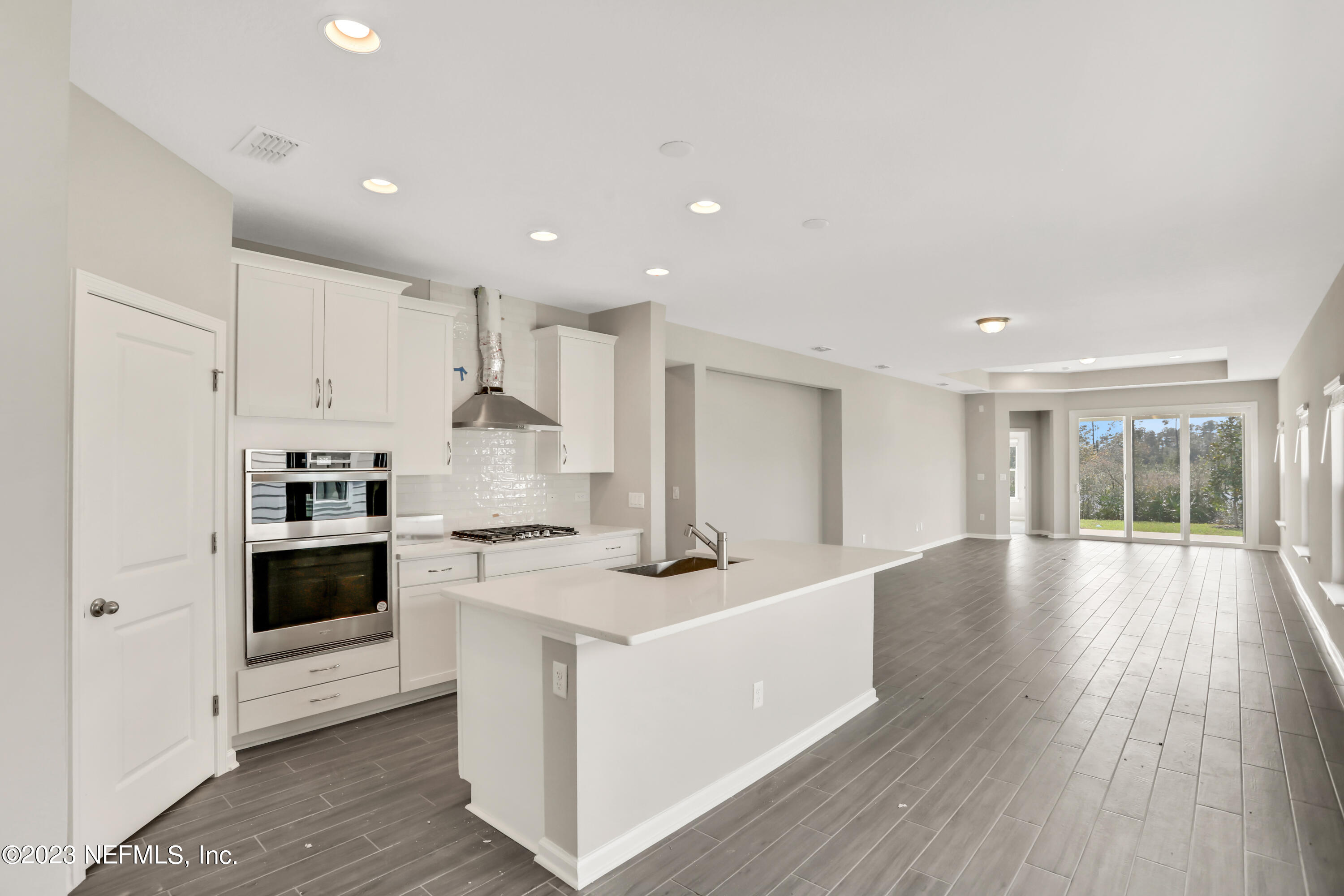 152 Torres Trace St. Augustine, FL 32095 - Photo 4 of 32 a kitchen with stainless steel appliances granite countertop a stove and a sink
