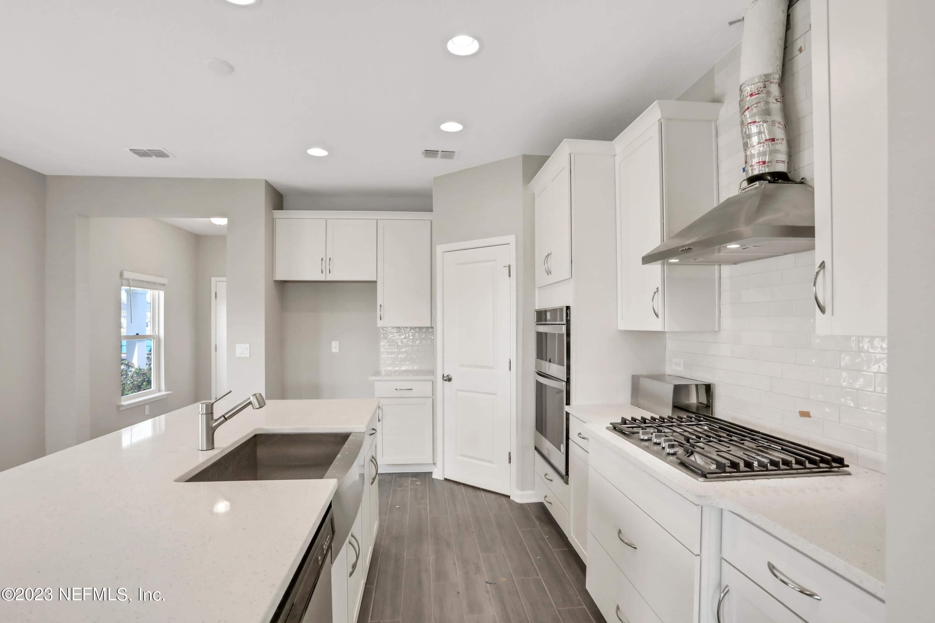 152 Torres Trace St. Augustine, FL 32095 - Photo 5 of 32 a kitchen with a sink a stove and refrigerator