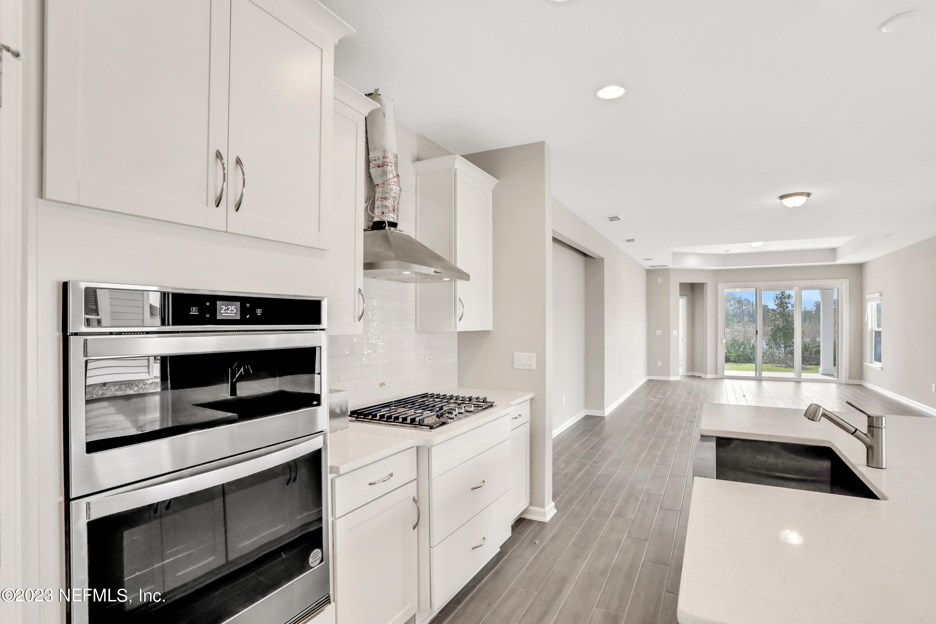 152 Torres Trace St. Augustine, FL 32095 - Photo 8 of 32 a kitchen with granite countertop white cabinets and appliances