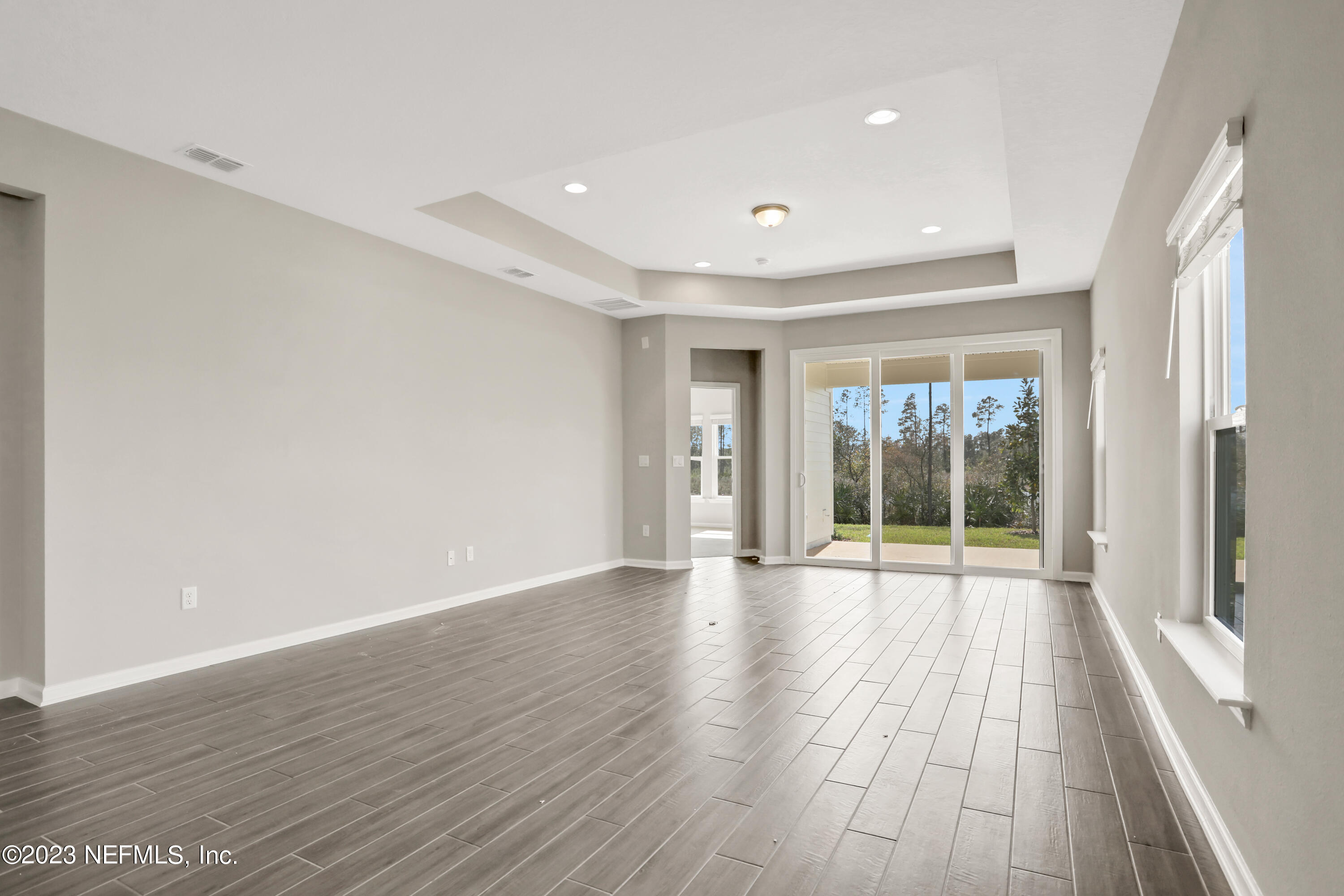 152 Torres Trace St. Augustine, FL 32095 - Photo 10 of 32 a view of an empty room with wooden floor and a window