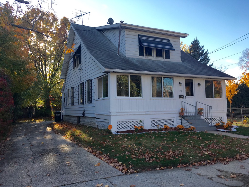 a front view of a house with garden