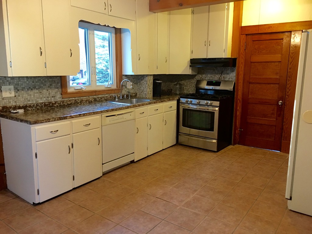 132 Windemere Street Springfield, MA 01104 - Photo 3 of 20 a kitchen with granite countertop a stove a sink and a refrigerator