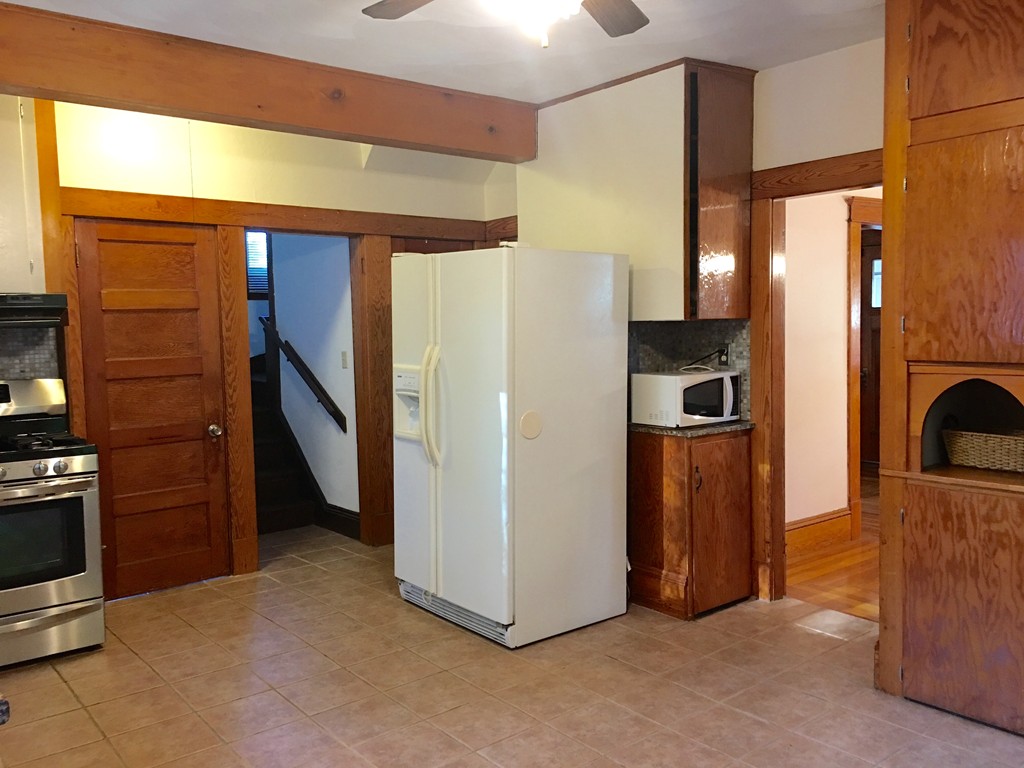 132 Windemere Street Springfield, MA 01104 - Photo 4 of 20 a view of a refrigerator in kitchen and a window