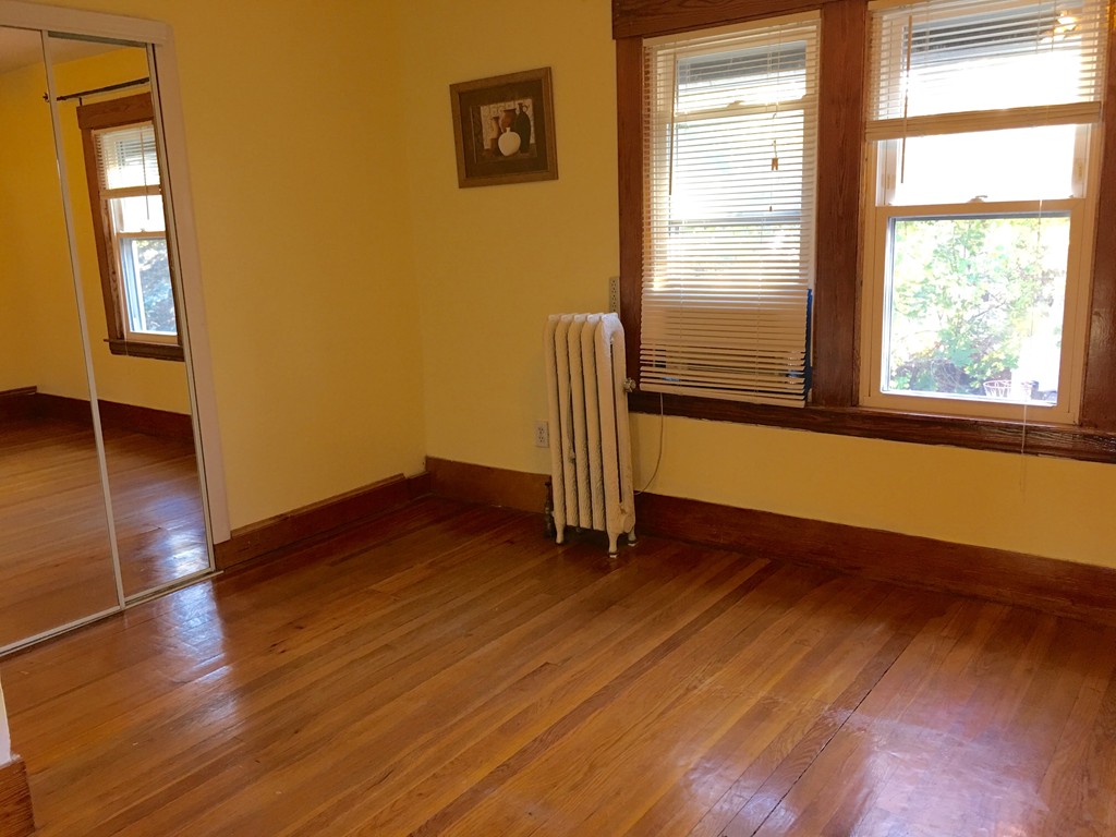 132 Windemere Street Springfield, MA 01104 - Photo 10 of 20 an empty room with wooden floor and windows