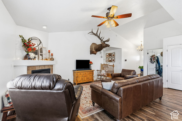 9044 North Cedar Pass Road Eagle Mountain, UT 84005 - Photo 10 of 63 Vaulted ceiling with an attached ceiling fan, corner fireplace with tile surround, wood-finish flooring, and white interior doors