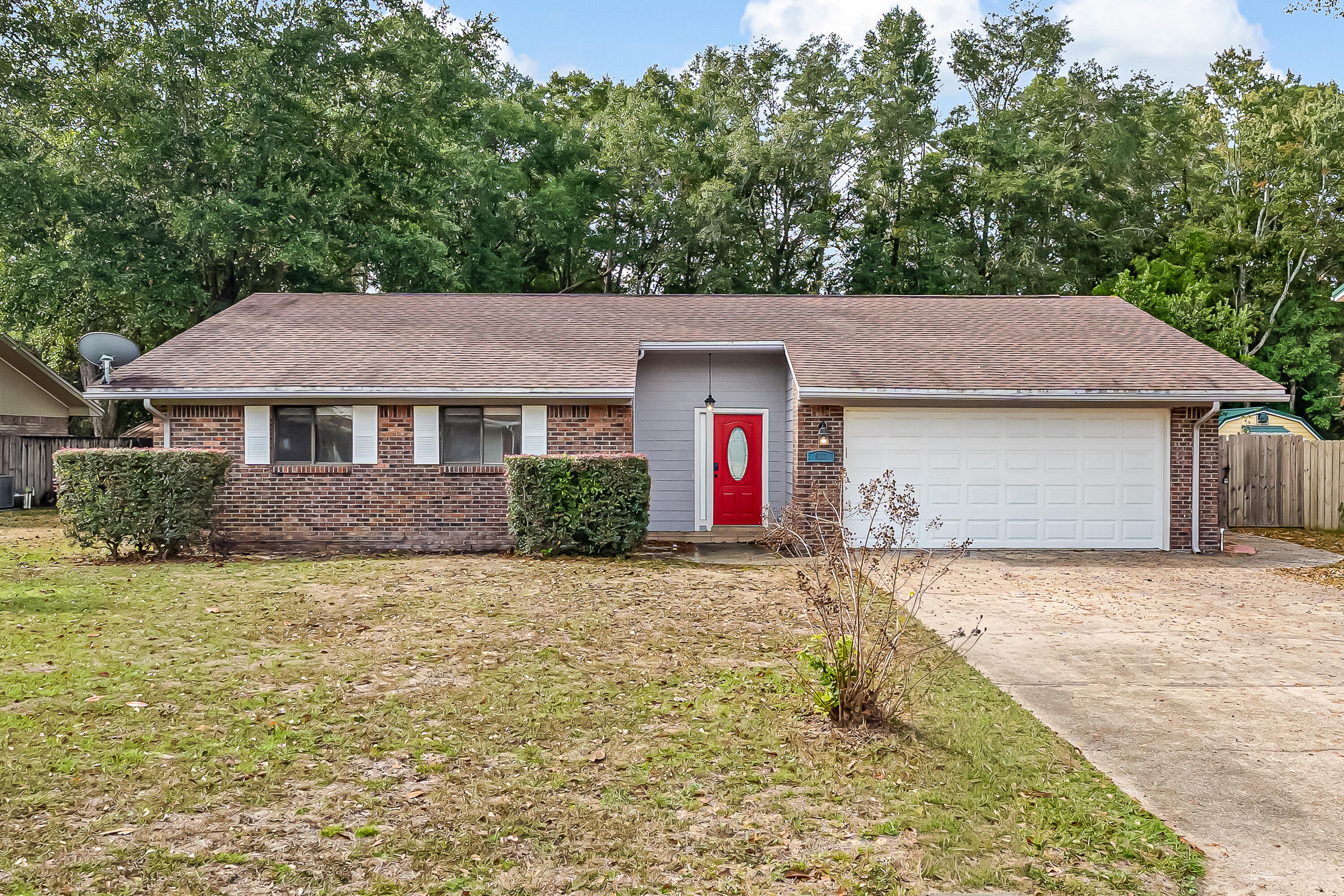 613 Caribbean Way Niceville, FL 32578 - Photo 1 of 27 a front view of a house with a yard and garage